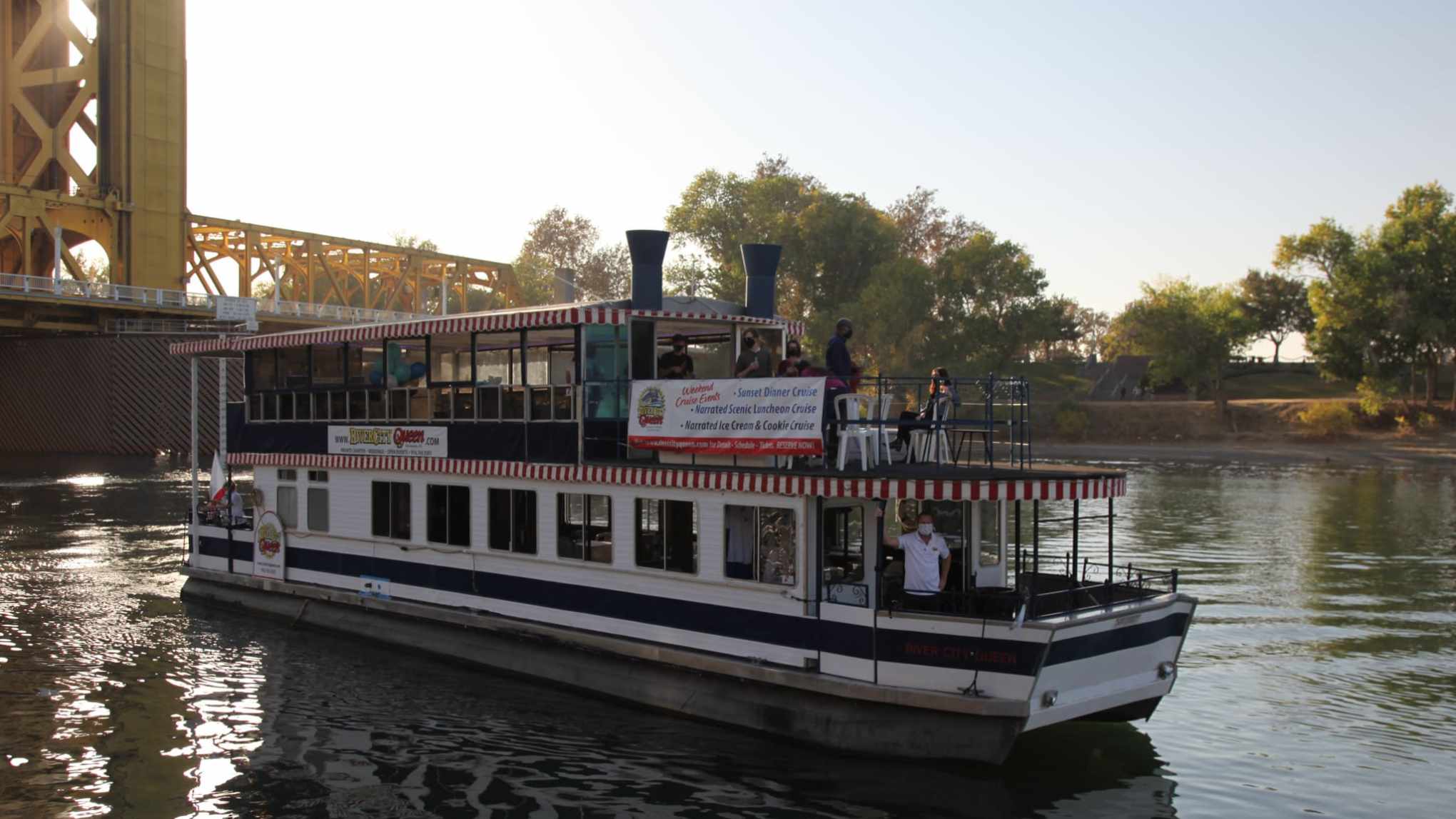 a boat traveling across a bridge over a body of water